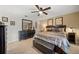 Comfortable main bedroom with a dark wood dresser and nightstands with tasteful decor and a ceiling fan at 8244 Brentwood Rd, Seminole, FL 33777