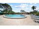 Community pool surrounded by lounge chairs and lush landscaping, perfect for relaxation and socializing at 8244 Brentwood Rd, Seminole, FL 33777