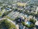 Aerial view of the community with tennis courts, a clubhouse, and a pool at 8244 Brentwood Rd, Seminole, FL 33777