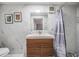 Bathroom with a modern vanity, marble tiled wall, updated fixtures and shower with mosaic tiled floor at 8816 Memorial Hwy, Tampa, FL 33615