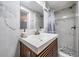 Bathroom with a modern vanity, marble tiled wall and a shower with a glass door and updated fixtures at 8816 Memorial Hwy, Tampa, FL 33615