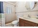 Tiled bathroom featuring a glass block window above a tiled shower and an updated vanity at 8816 Memorial Hwy, Tampa, FL 33615