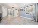 Neutral primary bedroom featuring tile floors, mirror closet doors and natural light from the window at 8816 Memorial Hwy, Tampa, FL 33615