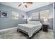 Neutral toned bedroom featuring bright natural light with a ceiling fan and minimalist décor at 8816 Memorial Hwy, Tampa, FL 33615
