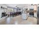Open-concept dining area adjacent to a kitchen with updated stainless appliances, granite countertops, and island at 8816 Memorial Hwy, Tampa, FL 33615