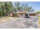 Charming single-story home with a well-manicured lawn and driveway at 8816 Memorial Hwy, Tampa, FL 33615