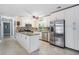 Updated kitchen features stainless steel appliances, granite countertops, and white cabinets at 8816 Memorial Hwy, Tampa, FL 33615