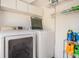 Bright laundry room featuring modern appliances and ample storage shelving at 8816 Memorial Hwy, Tampa, FL 33615
