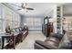 Cozy living room featuring neutral paint, windows with blinds, ceiling fan, and leather sofas at 8816 Memorial Hwy, Tampa, FL 33615