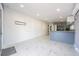 Bright, open-concept living area seamlessly connects to the kitchen, featuring modern flooring and recessed lighting at 8816 Memorial Hwy, Tampa, FL 33615