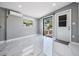 Well lit room with white floors and access to backyard dock at 8816 Memorial Hwy, Tampa, FL 33615