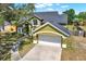 Aerial view of a two-story house with a green lawn, showcasing the roof and driveway at 9603 Sunnyoak Dr, Riverview, FL 33569