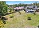 Large grassy backyard with a screened-in pool and wood fence at 9603 Sunnyoak Dr, Riverview, FL 33569