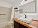 Bathroom featuring a modern sink, wood countertop, lighted mirror, and bathtub with shower at 9603 Sunnyoak Dr, Riverview, FL 33569