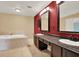 Contemporary bathroom with dual sinks, soaking tub, and modern fixtures at 9603 Sunnyoak Dr, Riverview, FL 33569