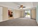 Primary bedroom features plush carpet and sliding door access to the backyard at 9603 Sunnyoak Dr, Riverview, FL 33569