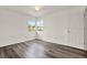 Bright bedroom featuring wood floors, white walls, a ceiling fan, and a window with natural light at 9603 Sunnyoak Dr, Riverview, FL 33569