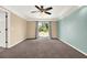 Spacious primary bedroom with neutral carpeting, crown molding, and sliding door to the outdoors at 9603 Sunnyoak Dr, Riverview, FL 33569