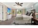 Stylish primary bedroom featuring a king bed, neutral decor, and a door to the back yard at 9603 Sunnyoak Dr, Riverview, FL 33569