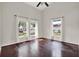Spacious bedroom with hardwood floors, high ceilings, three large windows, and neutral decor at 9603 Sunnyoak Dr, Riverview, FL 33569