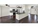 Modern kitchen with stainless steel appliances, island with bar stools, and breakfast nook area at 9603 Sunnyoak Dr, Riverview, FL 33569