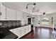 Well-lit kitchen with granite counters, stainless steel appliances, and breakfast bar at 9603 Sunnyoak Dr, Riverview, FL 33569