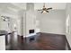 Open living room showcasing hardwood floors, a fireplace with shelving, and natural light at 9603 Sunnyoak Dr, Riverview, FL 33569