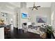 Open-concept living room with hardwood floors, a decorative fireplace, and a ceiling fan at 9603 Sunnyoak Dr, Riverview, FL 33569