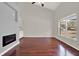 Living room with hardwood floors, electric fireplace, a large window, and neutral color scheme at 9603 Sunnyoak Dr, Riverview, FL 33569