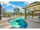 Inviting screened-in pool area featuring a swimming pool, hot tub, and covered patio with a ceiling fan at 9603 Sunnyoak Dr, Riverview, FL 33569