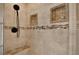 Modern shower featuring tiled walls, built-in niches, and a comfortable bench at 9603 Sunnyoak Dr, Riverview, FL 33569