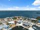 Beautiful aerial view of waterfront homes, private docks, and a calming ocean backdrop at 9920 Spoonbill E Rd, Bradenton, FL 34209