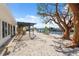 Waterfront property with shell landscaping, a pergola, dock access, and views of the tranquil canal at 9920 Spoonbill E Rd, Bradenton, FL 34209