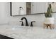 Stylish bathroom vanity features a marble countertop, sleek black faucet, and modern accents at 9920 Spoonbill E Rd, Bradenton, FL 34209