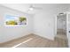 Bright bedroom featuring a ceiling fan, light wood floors, and natural light from the window at 9920 Spoonbill E Rd, Bradenton, FL 34209