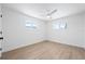 Bright bedroom with neutral paint, updated fan and wood-look flooring at 9920 Spoonbill E Rd, Bradenton, FL 34209
