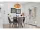 Cozy dining area with stylish light fixture and view to the backyard at 9920 Spoonbill E Rd, Bradenton, FL 34209
