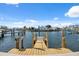 Waterfront dock with views of the surrounding boats, docks, and beautiful blue sky at 9920 Spoonbill E Rd, Bradenton, FL 34209