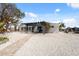 Charming home with a modern pergola, inviting curb appeal, and a well-maintained yard at 9920 Spoonbill E Rd, Bradenton, FL 34209