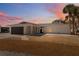 Single story home boasts attached garage, neutral color palette, gravel landscaping, and sidewalk at 9920 Spoonbill E Rd, Bradenton, FL 34209