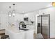Stylish kitchen featuring an island, stainless steel appliances and white cabinetry at 9920 Spoonbill E Rd, Bradenton, FL 34209