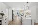 Kitchen featuring an island with counter seating, modern lighting, and a view of the water at 9920 Spoonbill E Rd, Bradenton, FL 34209