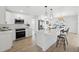 Modern, open kitchen with white cabinets, stainless steel appliances, and an island at 9920 Spoonbill E Rd, Bradenton, FL 34209