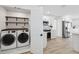 Well-equipped laundry room next to the bright kitchen with stainless steel appliances at 9920 Spoonbill E Rd, Bradenton, FL 34209