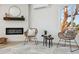 Cozy sitting area featuring a fireplace, mini-split AC unit, plank floors, and decorative furnishings at 9920 Spoonbill E Rd, Bradenton, FL 34209
