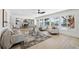 Bright open-concept living room with waterfront views from large windows and modern decor at 9920 Spoonbill E Rd, Bradenton, FL 34209