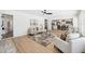 Open living room showcases plank floors, neutral decor, and flows seamlessly into the dining area and kitchen at 9920 Spoonbill E Rd, Bradenton, FL 34209