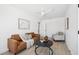 Cozy living room with neutral decor, plank flooring, and modern ceiling fan at 9920 Spoonbill E Rd, Bradenton, FL 34209