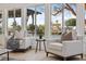 Inviting living room area featuring natural light and waterfront views from large windows at 9920 Spoonbill E Rd, Bradenton, FL 34209