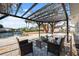 Cozy outdoor seating under a pergola with water views creating a relaxing atmosphere at 9920 Spoonbill E Rd, Bradenton, FL 34209
